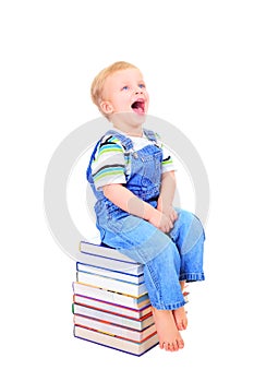 Cute little boy is reading a book