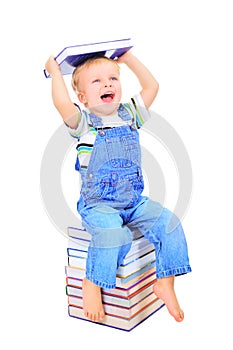 Cute little boy is reading a book