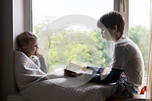Cute little boy reading book