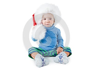 Cute little boy in the red furry Santa hat on white background