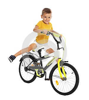 Cute little boy riding bicycle on white