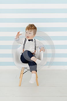 Cute Little Boy Sitting on Chair Displeased Child