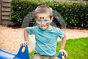 Cute little boy sitting on the swing