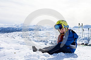 Cute little boy, skiing happily in Austrian ski resort in the mountains