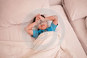 Cute little boy sleeping on the bed