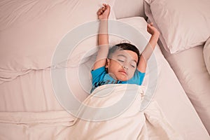 Cute little boy sleeping on the bed