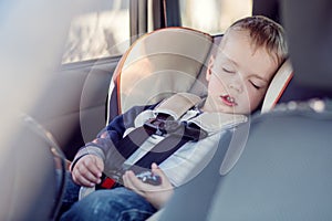 Cute little boy sleeping in car