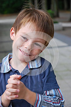Cute little boy smiles with malicious joy
