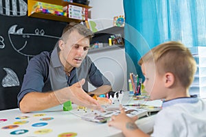 Cute little boy at speechtherapist session.