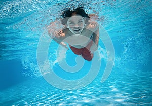 Cute little boy swimming in the pool