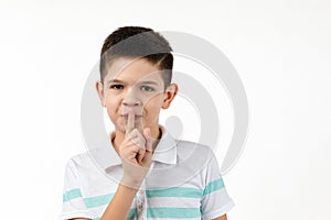 Cute little boy in t-shirt asking to be quiet