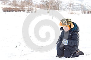 Cute little boy about to thow a snowball photo