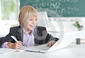 Cute little boy using laptop