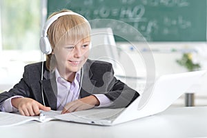 Cute little boy using laptop