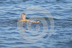 Cute little boy in the water making splashes