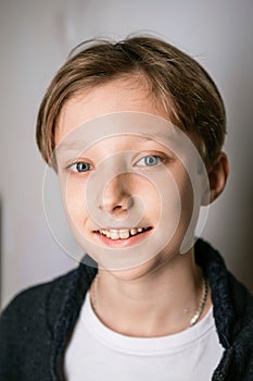 Cute little boy in white t-shirt and black sweater posing. Portrait