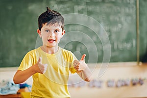 Cute little boy working in classroom