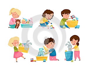 Cute little boys and girls cleaning up his toys and putting toys into boxes set. Kids doing housework chores at home