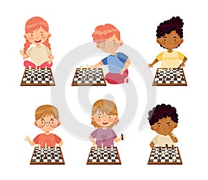 Cute little boys and girls playing strategy chess game set cartoon vector illustration