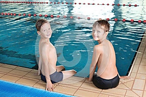 Cute little boys near indoor pool