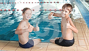 Cute little boys near indoor pool