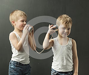 Cute little brothers talking on the toy phone