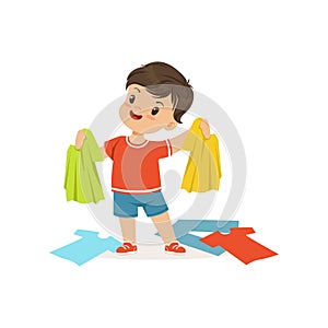 Cute little bully boy standing among scattered clothes, hoodlum cheerful little kid, bad child behavior vector