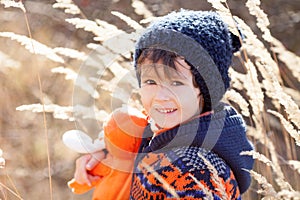 Cute little caucasian child, boy, holding fluffy toy, hugging it