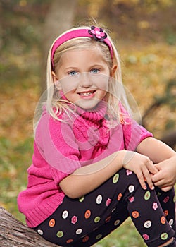 Cute little caucasian girl in pink sweater