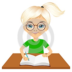 Cute little caucasian student girl writing