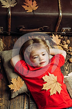 Cute little child boy are getting ready for autumn. The biggest discounts for all autumn clothes for children. Kid lies