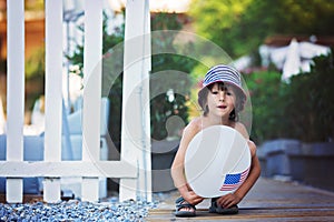 Cute little child, boy, playing with balloon with USA flag