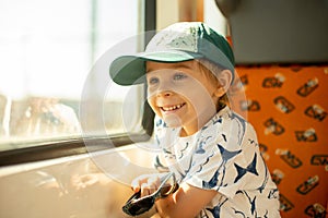 Cute little child, boy, traveling on a train