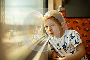 Cute little child, boy, traveling on a train