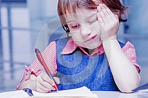 Cute little child girl having sad and bored while learning and m