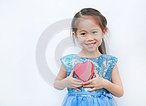 Cute little child girl holding red heart gift box for Valentine`s Day isolated on white background