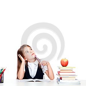 Cute little child girl looking up on the desk at school