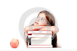 Cute little child girl looking up on the desk at school