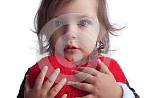 Cute little child girl portrait holding red heart toy on white b