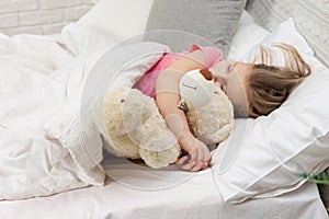 Cute little child girl sleeping with teddy bear