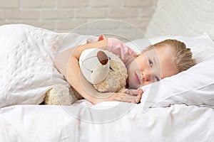 Cute little child girl sleeping with teddy bear