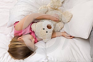 Cute little child girl sleeping with teddy bear