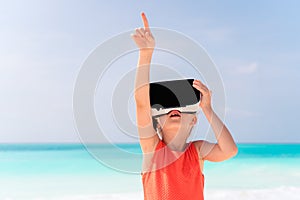 Kid wearing virtual reality glasses on beach
