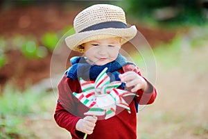 Cute little child holding toy windmill