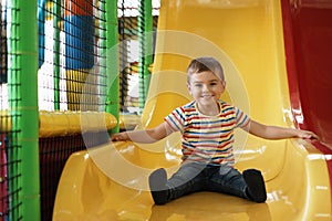 Cute little child playing at indoor park