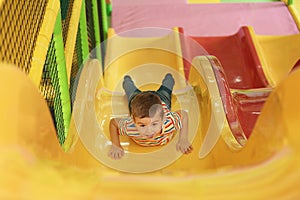 Cute little child playing at indoor park