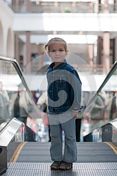 Cute little child in shopping center standing