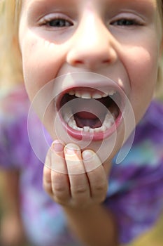 Cute Little Child Showing Off Wiggly Tooth photo