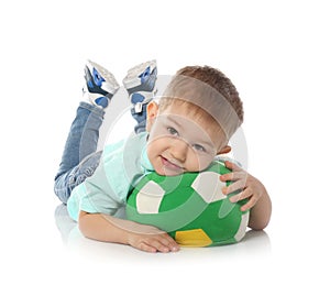 Cute little child with soft soccer ball on white. Playing indoors