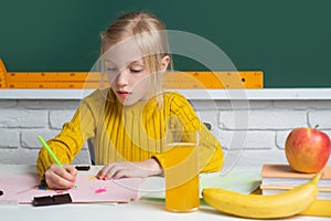 Cute little child studying in classroom at elementary school. Genius child, knowledge day. Kids education and knowledge.